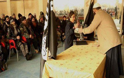 ISIS child soldier with an AK47 rifle given by his teacher pledges allegiance to the terrorist group