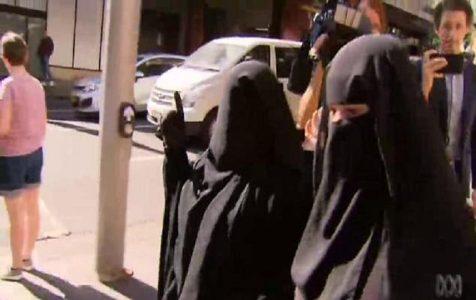 Terrorist recruiter’s burqa clad wife gives the ISIS salute after she refused to stand for a judge