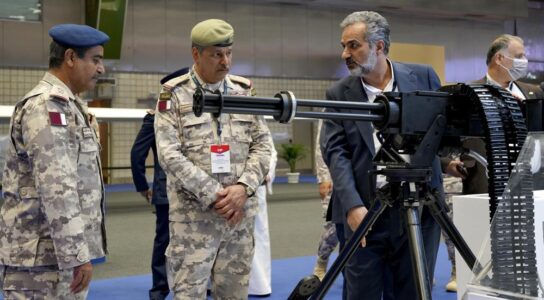 Under sweeping sanctions Iran hawks its weapons at a Qatari defense exhibit